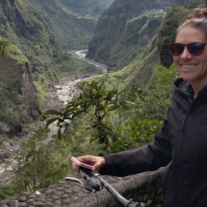 A Spanish student riding a bike with an overlook of the River