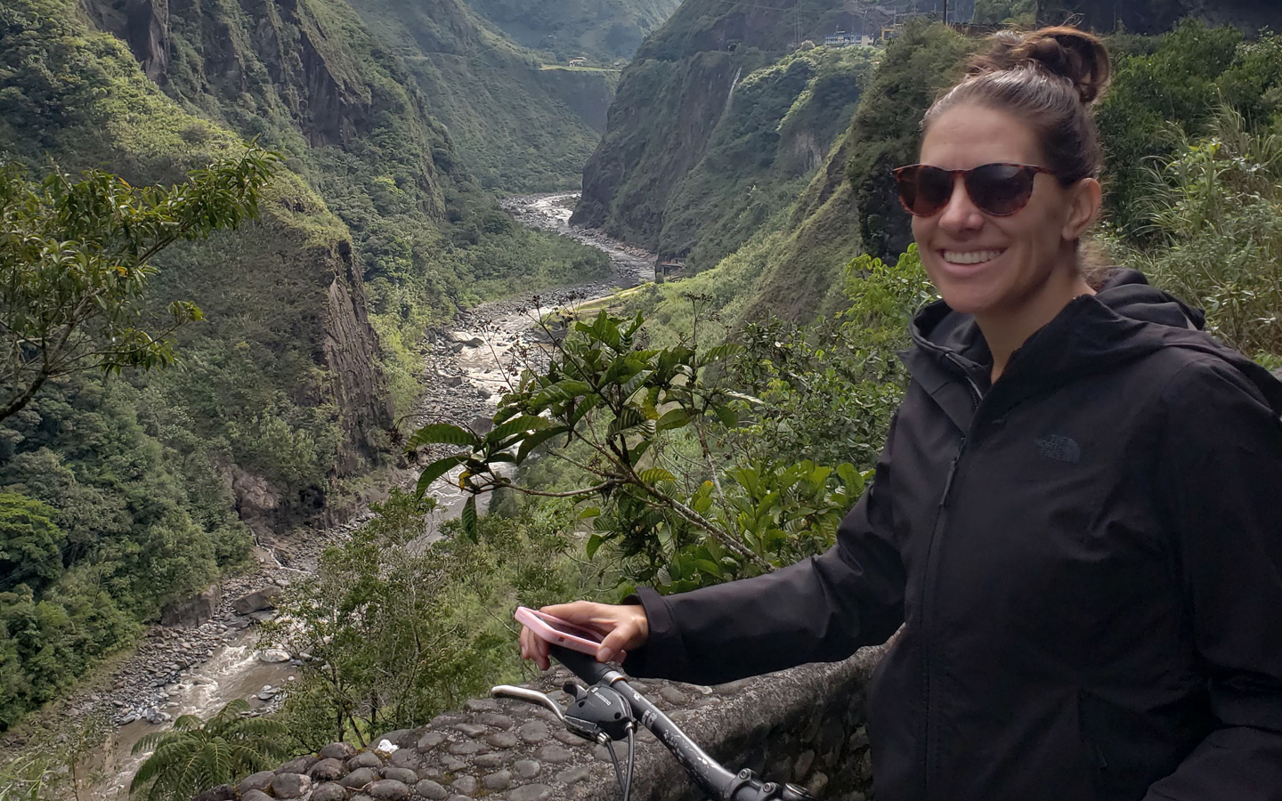 A Spanish student riding a bike with an overlook of the River