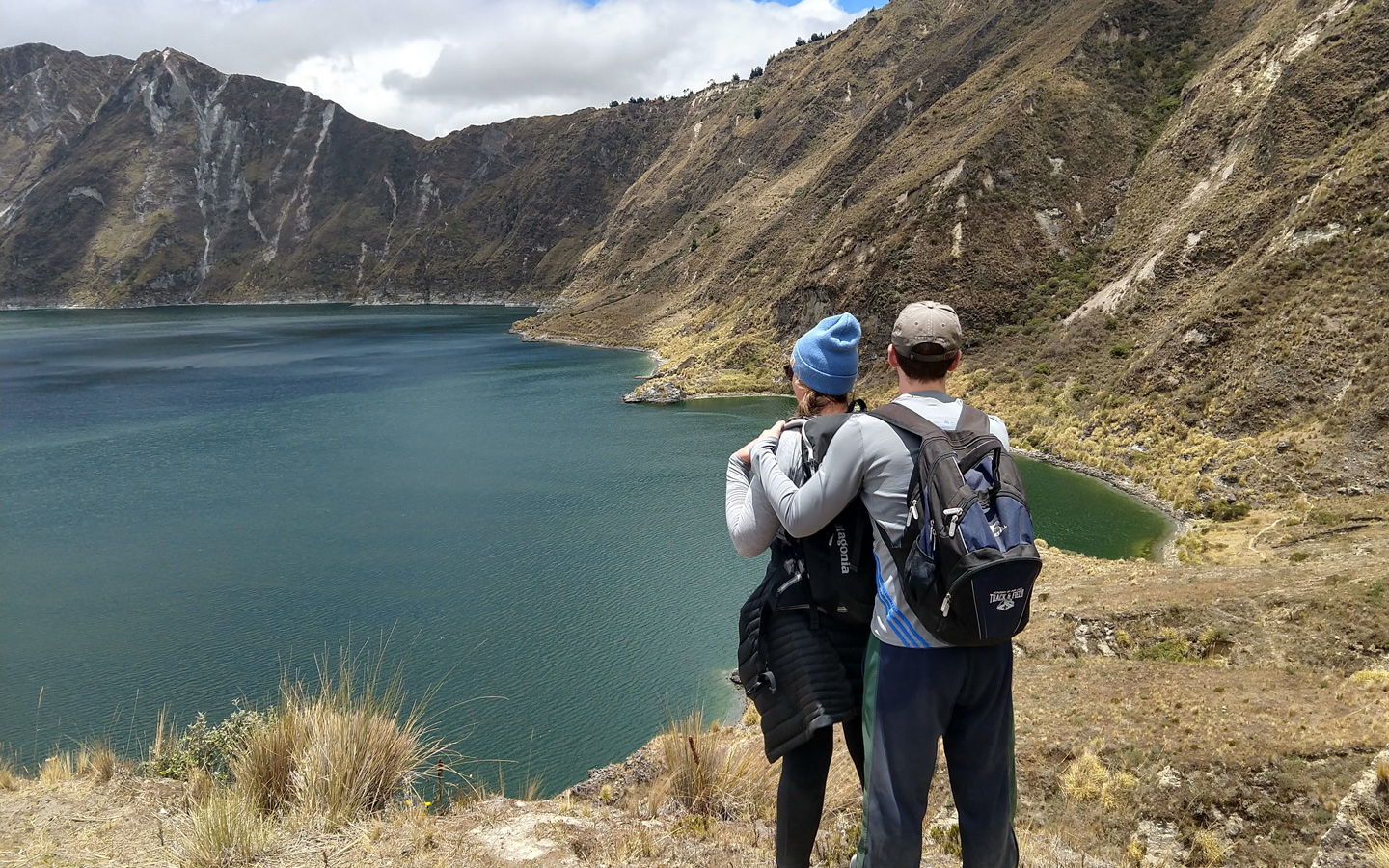 A couple at enjoying the romantic view of Quilotoa